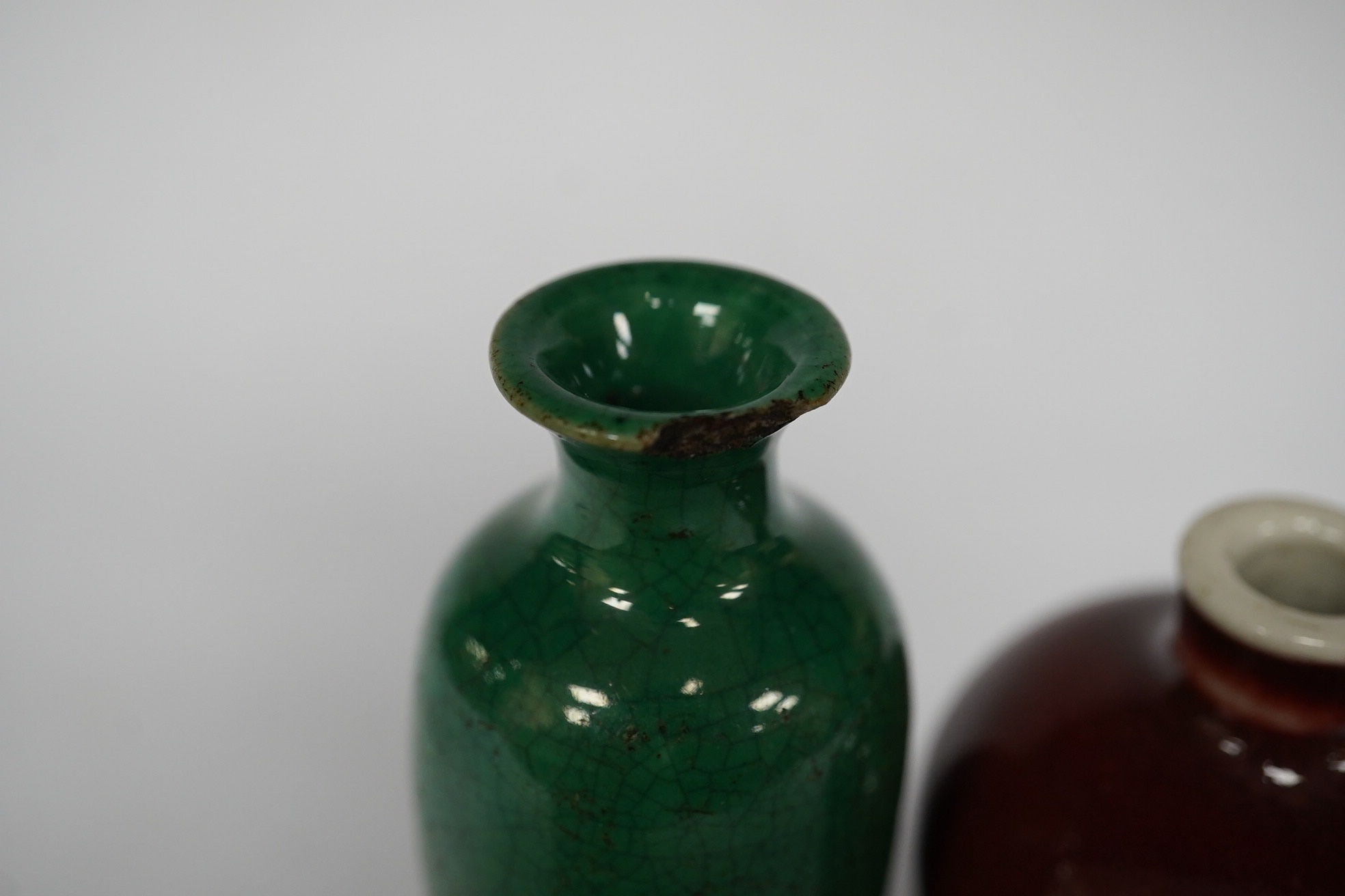A Chinese miniature green glazed vase and a sang de boeuf snuff bottle, both 18th/19th century, largest 9cm high overall. Condition - green glazed example with chip to top rim
